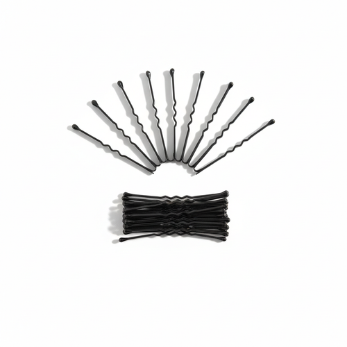Flatlay of 20 black bobby pins arranged on white background
